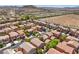 Aerial view of a neighborhood with terracotta roofs and beautiful mountain views at 6046 Bassio Ave, Las Vegas, NV 89141