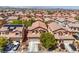 Aerial view of a neighborhood with terracotta-roofed homes and well-maintained landscaping at 6046 Bassio Ave, Las Vegas, NV 89141