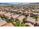 An aerial shot showcases closely packed homes and desert landscape with beautiful mountains at 6046 Bassio Ave, Las Vegas, NV 89141