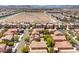 Overhead neighborhood shot with desert views and terracotta roofs, capturing community living at 6046 Bassio Ave, Las Vegas, NV 89141