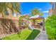 Backyard with a turf area and a dining area with a grill and gazebo at 6046 Bassio Ave, Las Vegas, NV 89141