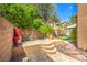 Cozy backyard with stone accents, potted plants, and a low brick wall at 6046 Bassio Ave, Las Vegas, NV 89141