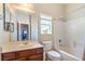 Bathroom features a vanity with a sink, a mirror and a bathtub with white tile at 6046 Bassio Ave, Las Vegas, NV 89141