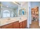 This bathroom features double sinks, granite countertops, and a walk-in closet at 6046 Bassio Ave, Las Vegas, NV 89141