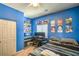 A bright bedroom with a window, shelving and plenty of room to study at 6046 Bassio Ave, Las Vegas, NV 89141