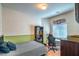 Bedroom featuring a study area with green and white walls and a window at 6046 Bassio Ave, Las Vegas, NV 89141