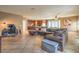 Expansive living area displaying an open layout with a sectional sofa, kitchen, and desk space at 6046 Bassio Ave, Las Vegas, NV 89141