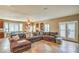 Comfortable living room showcasing an expansive sectional sofa, fireplace, and adjoining dining area at 6046 Bassio Ave, Las Vegas, NV 89141