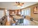 Open-concept living room with wood-look tile flooring, dining area, and updated kitchen with granite countertops at 6046 Bassio Ave, Las Vegas, NV 89141