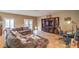 Spacious living room with tile floors, featuring a large entertainment center and French doors leading to the outside at 6046 Bassio Ave, Las Vegas, NV 89141