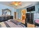 This main bedroom has blue walls and two black dressers, plus a ceiling fan at 6046 Bassio Ave, Las Vegas, NV 89141