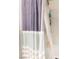 Neutral colored shower curtain hangs in a marble designed bathtub area with shower caddy at 6047 Ancient Peaks Ave, Las Vegas, NV 89141