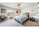 Charming bedroom featuring a wooden bed frame, accent furniture and a ceiling fan at 6047 Ancient Peaks Ave, Las Vegas, NV 89141
