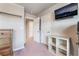 Bedroom with neutral walls, an open double door, a mounted TV, carpet, and modern furnishings at 6047 Ancient Peaks Ave, Las Vegas, NV 89141