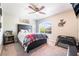Comfortable bedroom with a ceiling fan, queen bed, zebra wall decor and natural light at 6047 Ancient Peaks Ave, Las Vegas, NV 89141