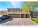 Stunning two-story home featuring a three-car garage and a beautifully paved driveway at 6047 Ancient Peaks Ave, Las Vegas, NV 89141