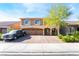 Attractive two-story home with a well-manicured front yard and spacious three-car garage at 6047 Ancient Peaks Ave, Las Vegas, NV 89141