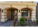 Inviting front porch with decorative pillars, a seating area, and a stylish front door at 6047 Ancient Peaks Ave, Las Vegas, NV 89141