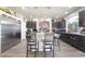 Spacious kitchen features an island with bar seating, stainless steel appliances, and modern light fixtures at 6047 Ancient Peaks Ave, Las Vegas, NV 89141