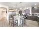 Bright kitchen showcasing a large island with seating, stainless steel refrigerator, and modern gray cabinets at 6047 Ancient Peaks Ave, Las Vegas, NV 89141