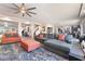 Expansive living area featuring modern furniture, an oversized ceiling fan, and ample natural light at 6047 Ancient Peaks Ave, Las Vegas, NV 89141