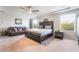 Large main bedroom featuring a seating area, neutral walls, carpet, and many windows at 6047 Ancient Peaks Ave, Las Vegas, NV 89141