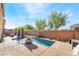 A narrow private pool offers a serene retreat with surrounding patio, seating, and landscaping at 6047 Ancient Peaks Ave, Las Vegas, NV 89141