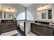 Elegant bathroom boasts dual sinks, granite counters, soaking tub, and a half-moon window, blending luxury with natural light at 6236 Desert Haven Rd, Las Vegas, NV 89130