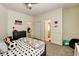 Comfortable bedroom with gray-wood bed, natural light, and view to en-suite bathroom at 6236 Desert Haven Rd, Las Vegas, NV 89130