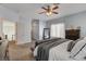 Bright bedroom showcasing soft lighting, a comfortable bed, and an inviting view of adjacent rooms and hallways at 6236 Desert Haven Rd, Las Vegas, NV 89130