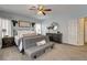 Bedroom features calming blue walls, plush carpeting, and a comfortable seating area for relaxation at 6236 Desert Haven Rd, Las Vegas, NV 89130