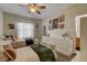 This bedroom features two beds, lots of art, and lots of natural light and neutral carpeting at 6236 Desert Haven Rd, Las Vegas, NV 89130