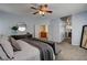 Large bedroom with light blue walls, comfortable seating, and doors leading to other areas of the home at 6236 Desert Haven Rd, Las Vegas, NV 89130