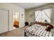 Comfortable bedroom with gray-wood bed, plenty of natural light, and view to en-suite bathroom at 6236 Desert Haven Rd, Las Vegas, NV 89130