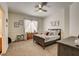 Neutral bedroom with grey wood bed, wall decor, and bright window at 6236 Desert Haven Rd, Las Vegas, NV 89130