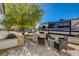 Relaxing front patio with stone pavers, a modern fire pit, mature landscaping, and inviting outdoor seating at 6236 Desert Haven Rd, Las Vegas, NV 89130