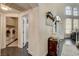 Welcoming hallway with dark floors, leading to laundry area and stairs, accented by decorative furniture and high ceilings at 6236 Desert Haven Rd, Las Vegas, NV 89130