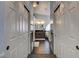 Hallway view leading to a bathroom, showcasing dark wooden floors and dual closets on either side at 6236 Desert Haven Rd, Las Vegas, NV 89130
