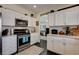 Well-lit kitchen with white cabinets, stainless steel appliances, and modern finishes at 6236 Desert Haven Rd, Las Vegas, NV 89130