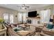 Inviting living room featuring a brick fireplace, large TV, neutral color palette and comfortable, plush seating at 6236 Desert Haven Rd, Las Vegas, NV 89130