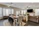 Open-concept living and dining area with fireplace, large windows, and comfortable seating at 6236 Desert Haven Rd, Las Vegas, NV 89130