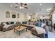Open-concept living room with large sectional sofa and adjacent kitchen, perfect for modern living and entertaining at 6236 Desert Haven Rd, Las Vegas, NV 89130