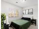 A bright bedroom features a queen bed, a window with blinds, and three framed pictures at 6299 Oread Ave, Las Vegas, NV 89139