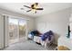 Cozy bedroom with ceiling fan, plush carpeting, and a sliding glass door to private balcony at 6299 Oread Ave, Las Vegas, NV 89139