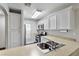 Bright kitchen featuring stainless steel appliances, light countertops, and white cabinets for ample storage at 6299 Oread Ave, Las Vegas, NV 89139