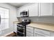 Bright kitchen featuring stainless steel oven, microwave, light countertops, and white cabinets at 6299 Oread Ave, Las Vegas, NV 89139