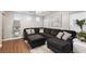 Comfortable living room featuring a large sectional sofa, plush ottoman, and bright windows with a modern decor at 6299 Oread Ave, Las Vegas, NV 89139