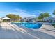 Sparkling community pool area with lounge chairs, covered seating, and well-maintained landscaping at 6299 Oread Ave, Las Vegas, NV 89139