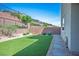 Low maintenance back yard with artificial grass and rock landscaping at 6433 Farness St, Las Vegas, NV 89135