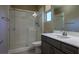 Modern bathroom featuring a glass-enclosed shower, white vanity with gray cabinets at 6433 Farness St, Las Vegas, NV 89135
